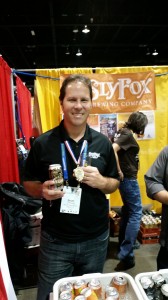 Brian O'Reilly shows off his gold medal and silver can at the 2014 Great American Beer Festival