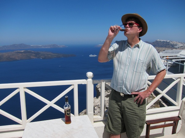 The author, drinking wine in Santorini