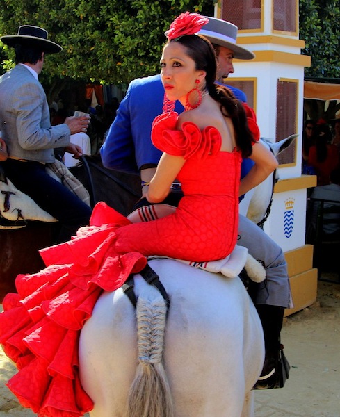 A couple rides in the Feria de Caballo.